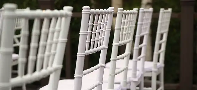 row of white rental chairs